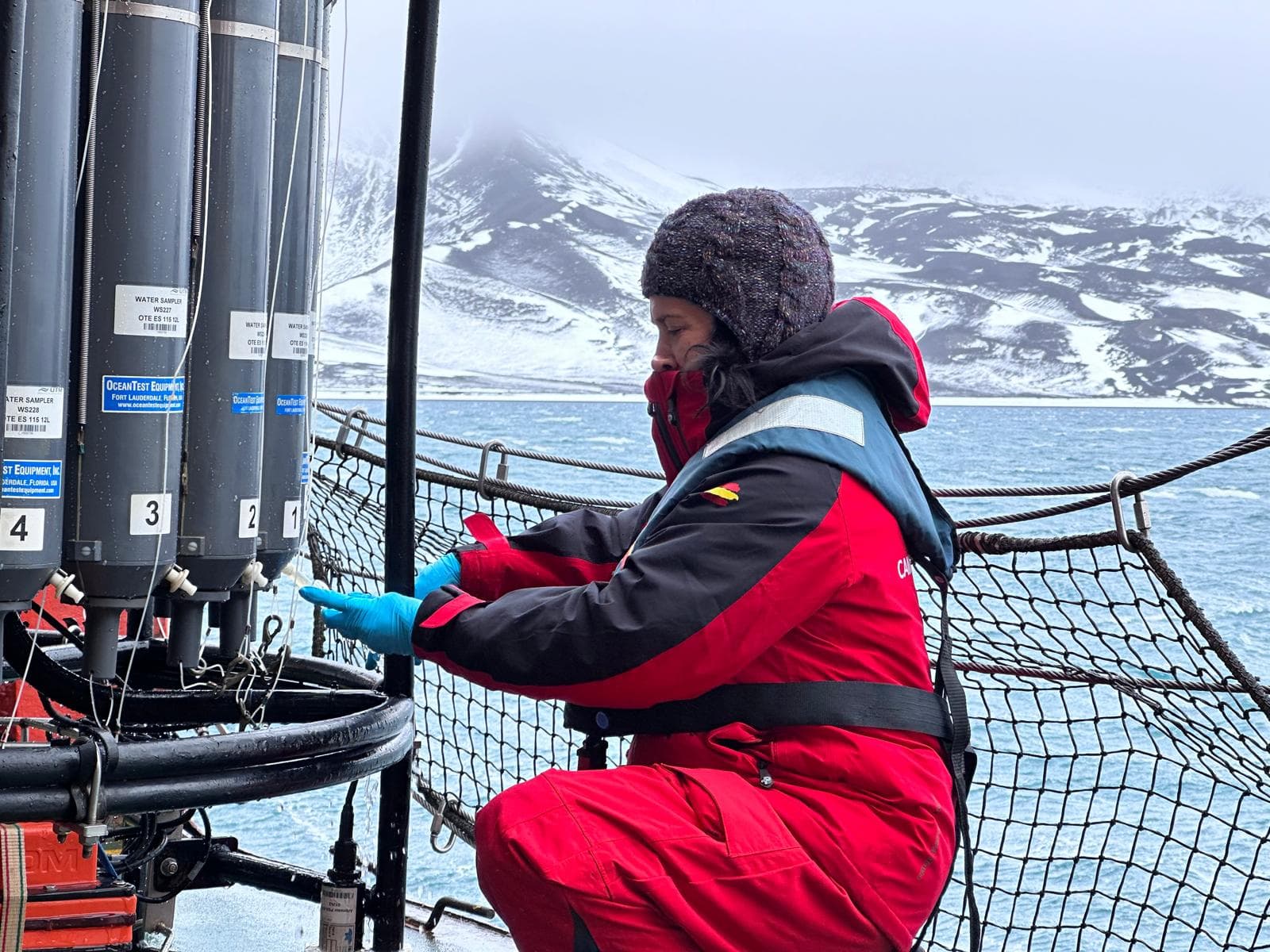 Susana Flecha sampling seawater from the CTD rosette on deck, in Antarctic waters