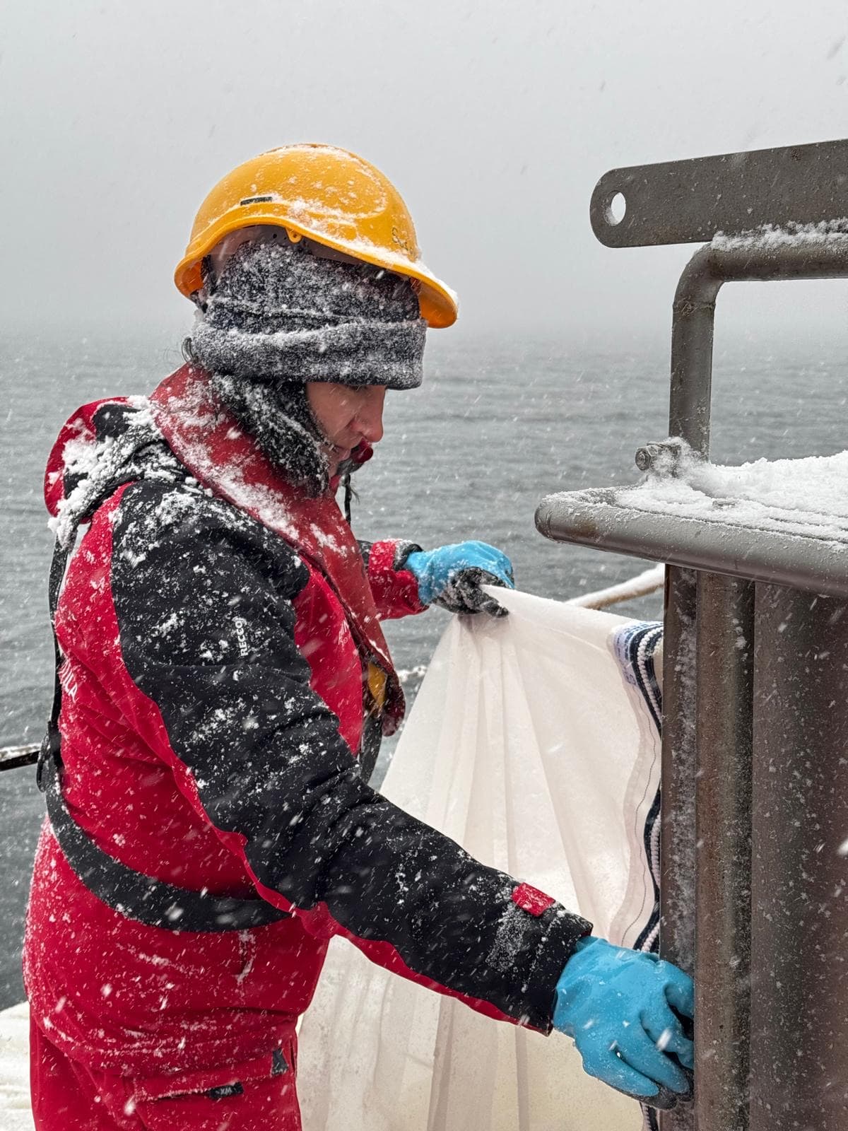 Sampling on deck during an Antarctic snowstorm