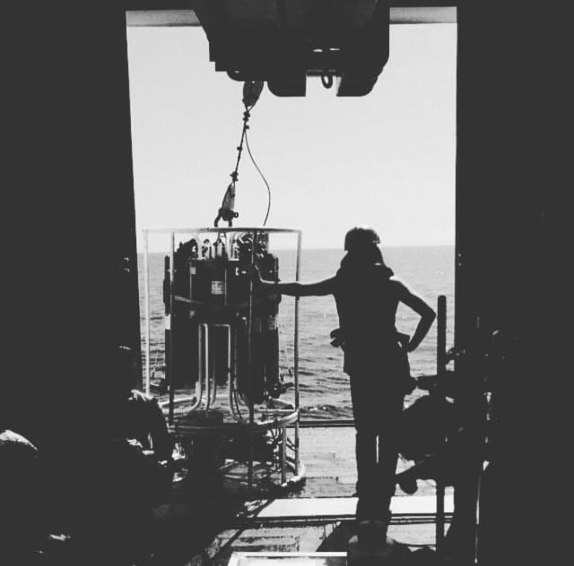Deploying a CTD rosette from the deck during open-ocean sampling operations