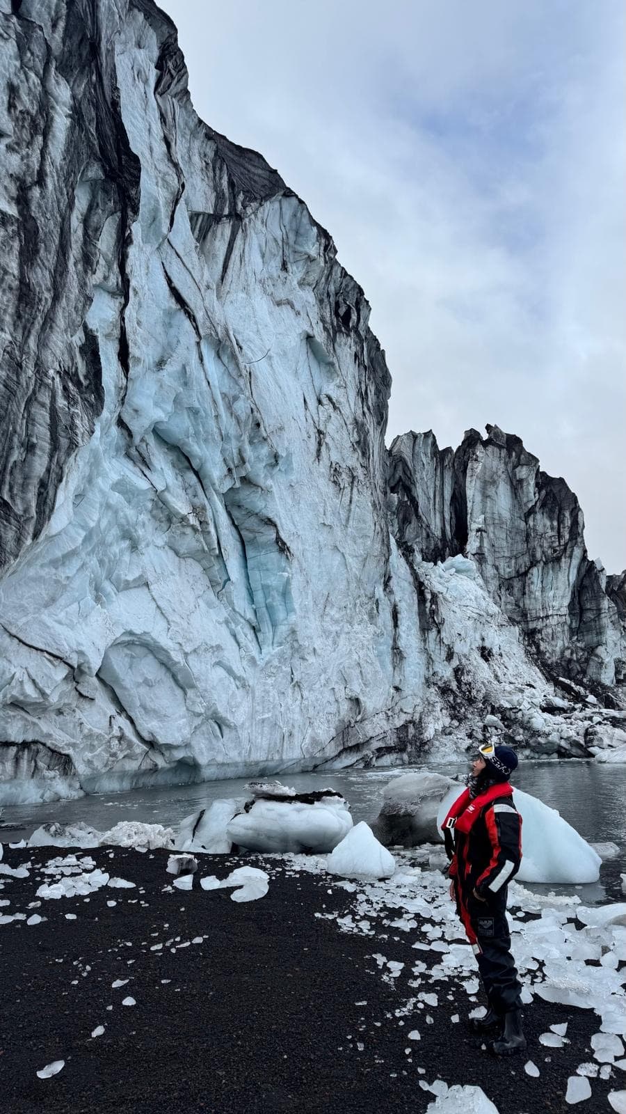 Surveying a tidewater glacier wall on a volcanic beach, western Antarctic Peninsula